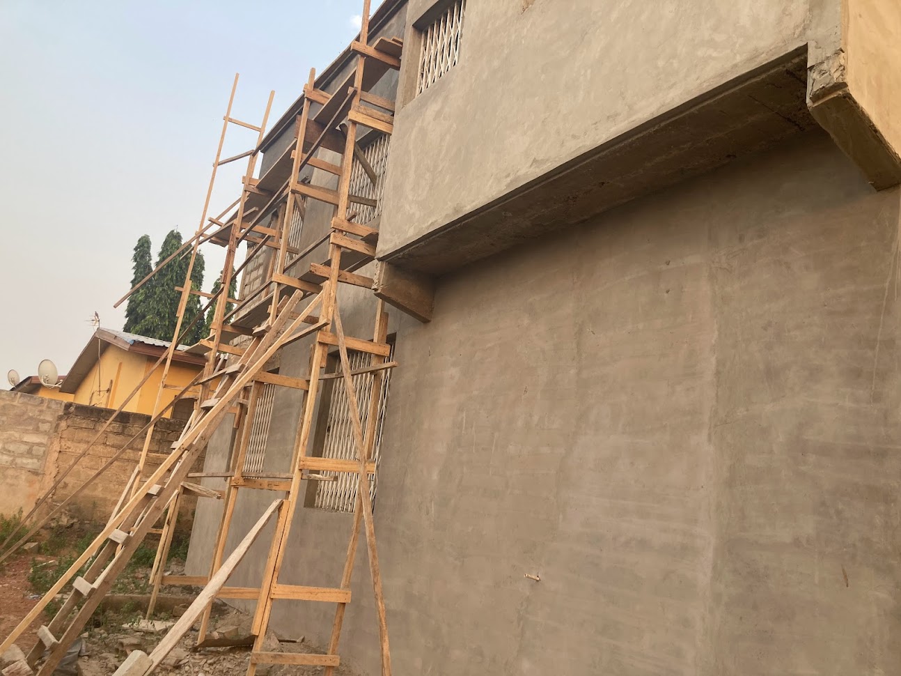 Multi-storey building under construction with timber scaffolding in Ghana — structural engineering and construction supervision